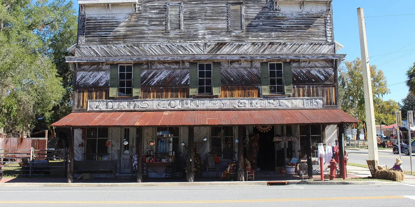 Weathered two-story wooden country store with a long porch