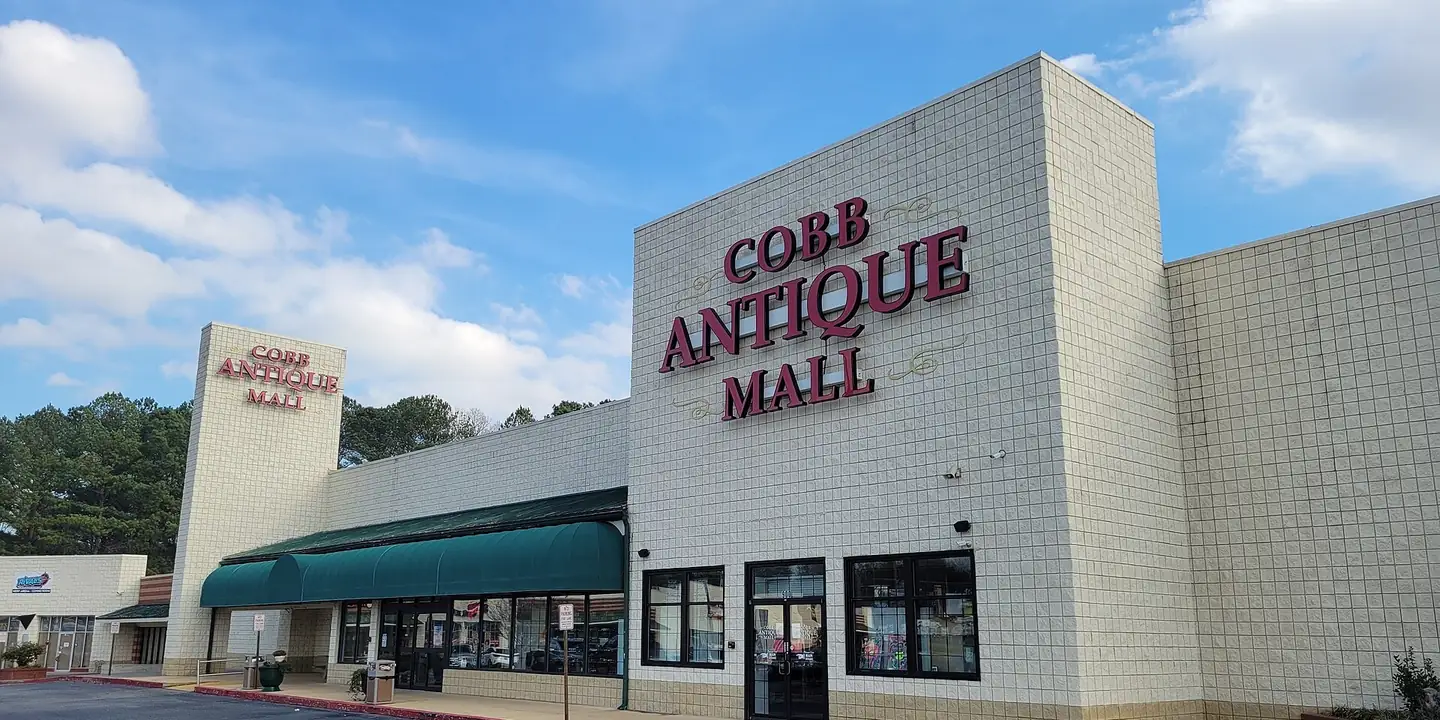 Large white building with red Cobb Antique Mall lettering