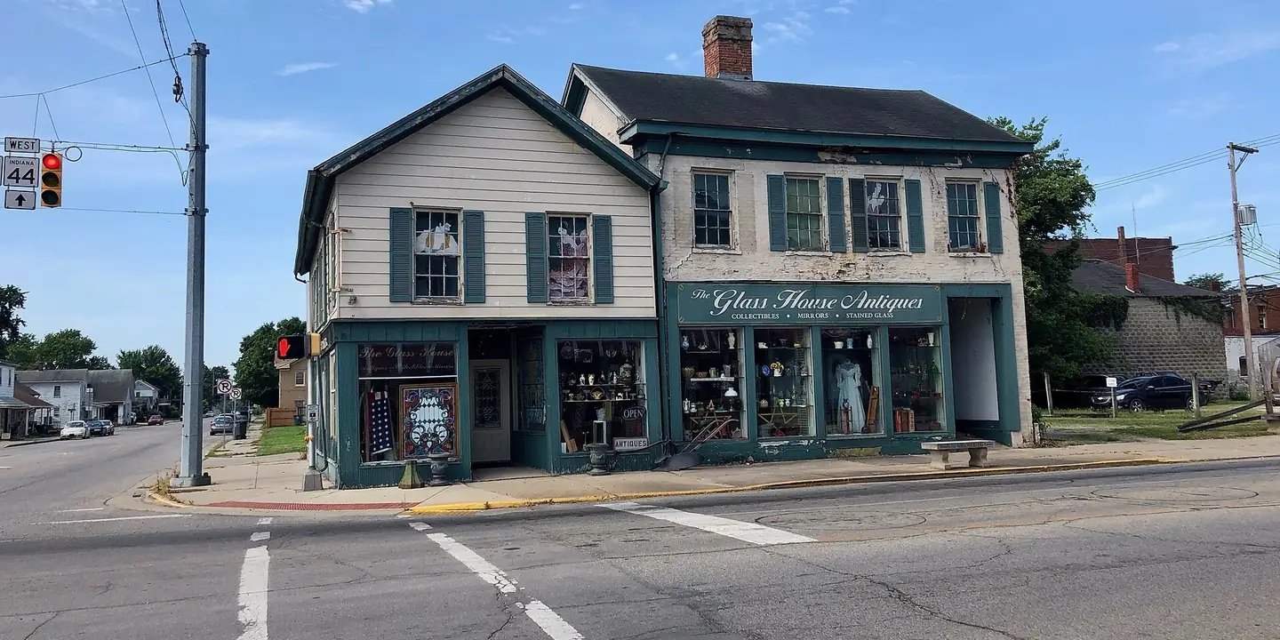Two-story corner shop building with a Glass House Antiques sign