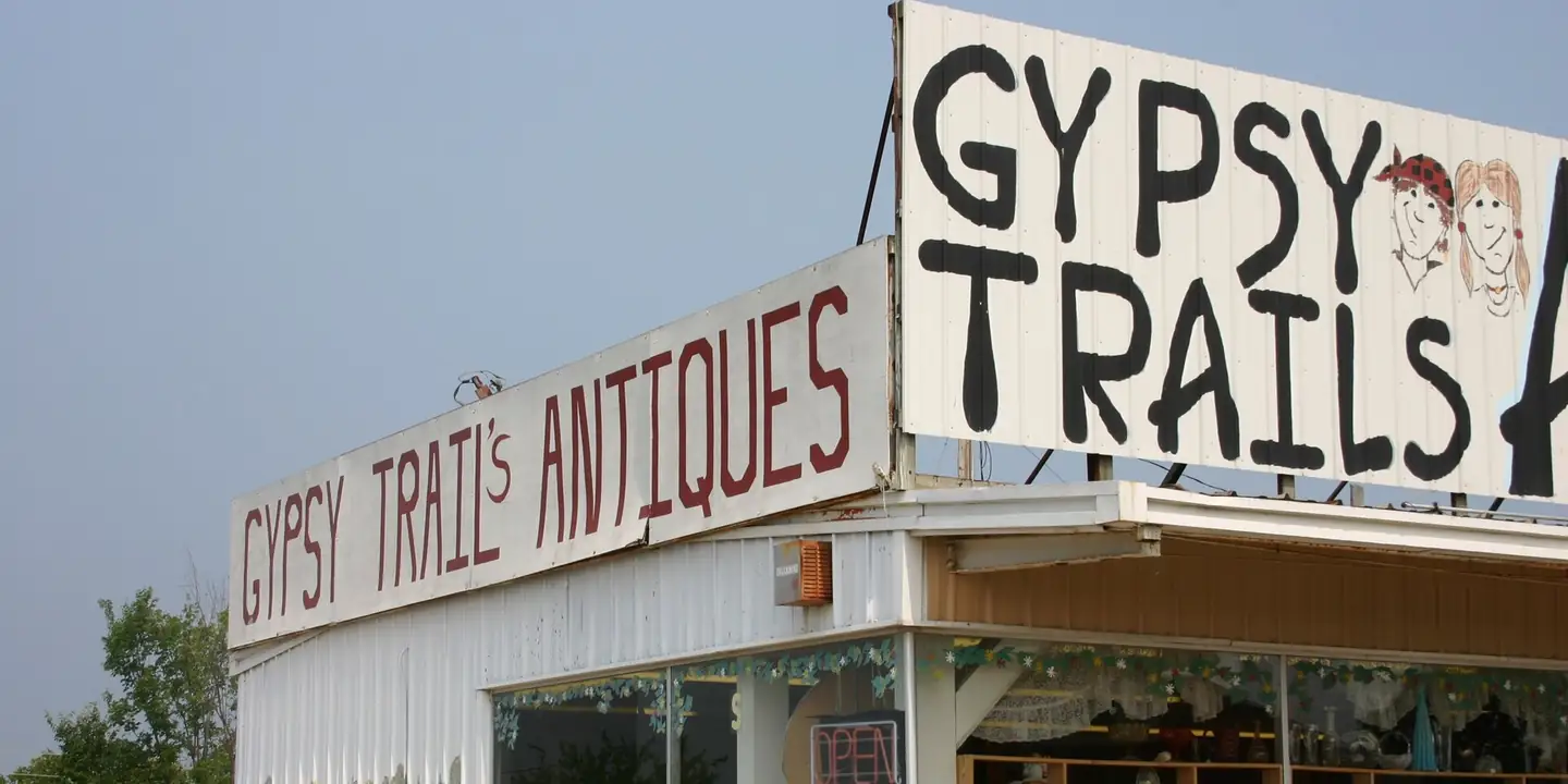 Hand-painted Gypsy Trails Antiques signs on a store roof